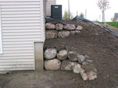 a pile of rocks sitting next to a house