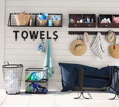 there is a towel rack with towels and other items on the wall next to it