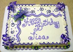 a birthday cake with purple and white frosting