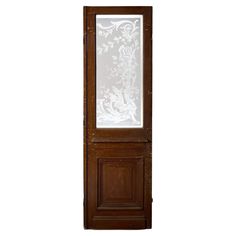 a tall wooden door with glass panels on the top and bottom panel inlayed to it