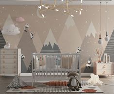 a baby's room decorated in neutral colors with mountains and panda bears on the wall