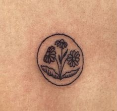 a small tattoo on the back of a person's stomach