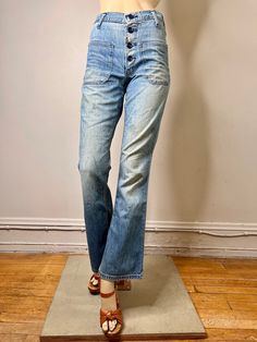 "Here is a great pair of vintage 60s/70s jeans. The denim on these is worn to perfection. They are a button fly, patch pockets on the front hips and on the butt, flared jeans. The jeans are by Maverick they are labeled 28 X 32 but see below for true measurements. They are in good condition. There are repairs to the bottom of the button fly and to the denim between two buttons on the button fly (see last pic). These repairs have been backed with vintage denim. There are also some paint spots on t 1970s Fitted Jeans, 1970s Denim Bottoms With Pockets, 1970s Full Length Denim Bottoms, 1970s Medium Wash Denim Jeans, 70s Jeans, 1970s Full-length Denim Jeans, Jane Birkin, Button Fly Jeans, Boho Festival