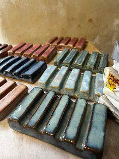 several different colored tiles sitting on top of a wooden table