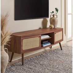 a flat screen tv mounted to the side of a wooden entertainment center in a living room