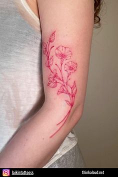 a woman's arm with a flower tattoo on the left side of her arm