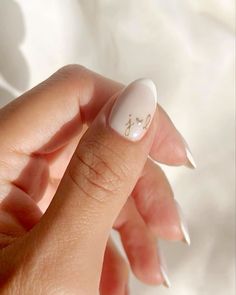 a woman's hand holding a white manicure with the word love on it