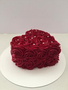 a cake with red icing on a white plate