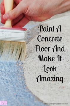 a hand holding a brush with the words paint a concrete floor and make it look amazing