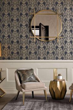 an elegant living room with gold accents and art deco wallpaper, including a round mirror on the wall