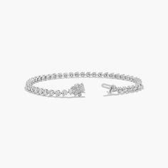 This classic tennis bracelet features a single row of scintillating brilliant cut diamonds set in finely crafted three prong baskets and closed by an elegant flower clasp. Ring Concierge, Jewelry Photoshoot, Diamond Tennis Bracelet, Elegant Flowers, Tennis Bracelet Diamond, Lab Created Diamonds, Tennis Bracelet, Brilliant Cut Diamond, Ring Sets