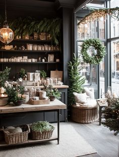 a room filled with lots of plants and christmas wreaths on the windows sill