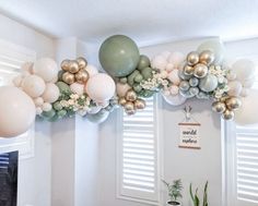 balloons and greenery are hanging from the ceiling