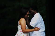 a man and woman standing next to each other with their arms around each other as they hug