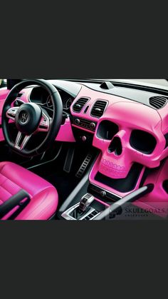 the interior of a car with pink leather and skulls on the steering wheel, center console and dash board