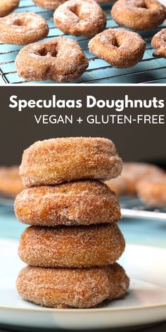 a stack of sugared doughnuts sitting on top of a white plate next to a cooling rack