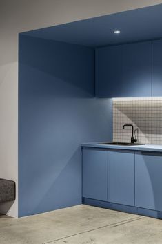 a kitchen with blue cabinets and a sink