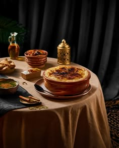 a table topped with lots of food on top of a brown table cloth covered table