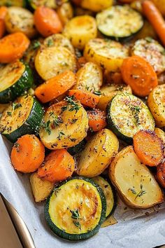 roasted vegetables on a baking sheet with herbs