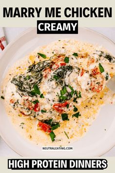 a white plate topped with chicken and spinach covered in cream sauce next to a fork