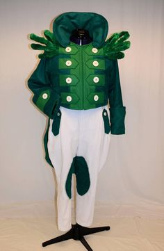 a green and white costume on a black stand