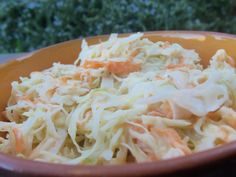 a bowl filled with coleslaw sitting on top of a table