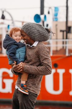 a man holding a small child in his arms