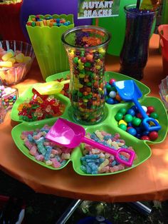 there are many different candy dishes on the table