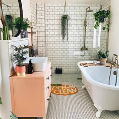 a white bath tub sitting next to a sink in a bathroom