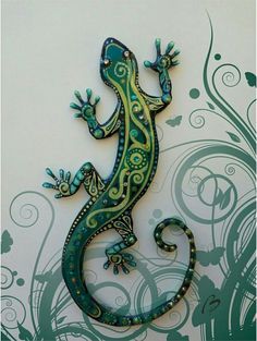 a green and yellow gecko sitting on top of a white wall