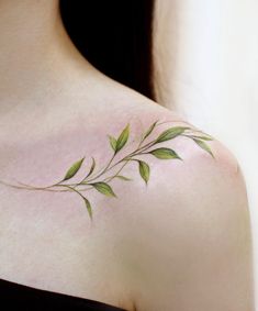 a woman's shoulder with green leaves on the top and bottom part of her body