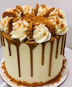 a cake with white frosting and chocolate drizzles