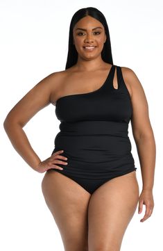 a woman in a black one piece swimsuit posing with her hands on her hips