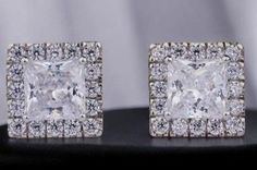 These princess Cut white moissanite diamond earrings are elegantly set in silver designed as classic stud earrings Perfect for weddings or special occasions they offer a refined sparkle that suits both party celebrations and everyday elegance An ideal anniversary gift these earrings are a beautiful choice for her combining timeless design with a touch of sophistication. ✿ 𝐌𝐚𝐢𝐧 𝐒𝐭𝐨𝐧𝐞 𝐃𝐞𝐭𝐚𝐢𝐥𝐬 ✿ ▸ Main Stone: Moissanite  ▸ Main Stone Shape: Princess Cut  ▸ Main Stone Dimension : 6x6 Silver Moissanite Earrings With Halo Design, Luxury Moissanite Earrings With Halo Setting, Classic Moissanite Earrings With Halo Setting, Vvs Clarity Diamond Bridal Earrings For Formal Occasions, Elegant Moissanite Cluster Earrings For Formal Occasions, Elegant Wedding Cluster Earrings With Lab Grown Diamonds, Elegant Cluster Earrings With Lab Grown Diamonds For Anniversary, Silver Moissanite Diamond Earrings With Halo Design, Dazzling Diamond Earrings With Halo Setting For Gift