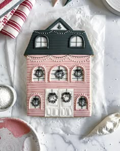 a pink house cookie sitting on top of a table