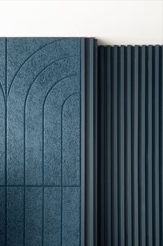 the side of a blue wall with vertical lines on it and an open radiator