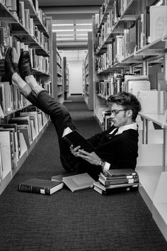 a man laying on the floor in a library