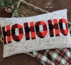 a crocheted pillow with the word hope written in red and black on it