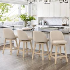 three stools in front of a kitchen island