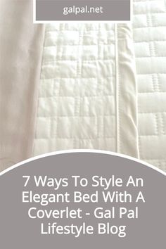 an elegant bed with a coverlet - gal pai lifestyle blog logo on it