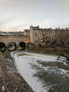 the water is rushing under the bridge and into the river to get some fresh air