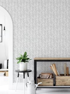 a living room with blue and white wallpaper, a coffee table and bookshelf