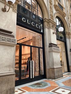 a gucci store in the middle of a building with an arched doorway and glass windows