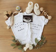 a baby's t - shirt and some toys are laying on the floor