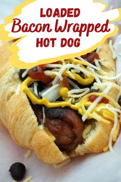 a hot dog covered in cheese and toppings