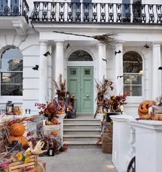 a house decorated for halloween with pumpkins and other decorations