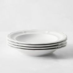 four white plates stacked on top of each other