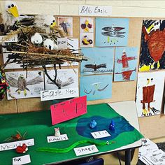 a table topped with lots of paper cut outs covered in birds nests and writing