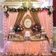 an elaborately decorated dessert table with pink and gold decor