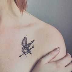 a woman with a bird tattoo on her chest and the words, or to the hungry games?